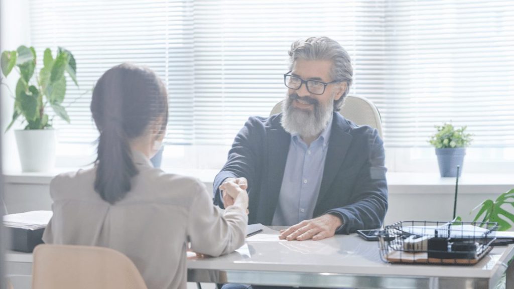 Shaking hands on new job - From the blog post How to Handle Chaos in QHSE at Your New Job at Qooling