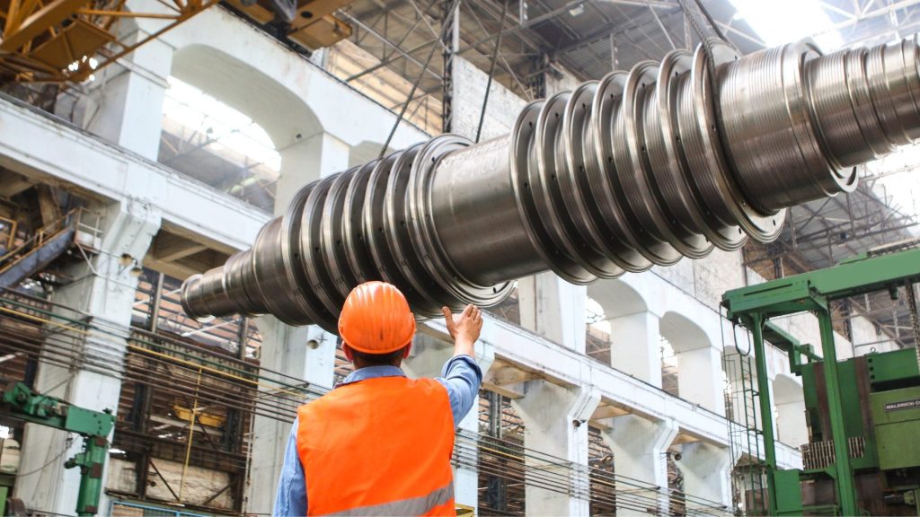 Man on work site looking at machine