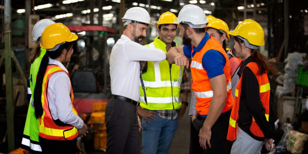 Men and women greeting each other on a working site with top management
