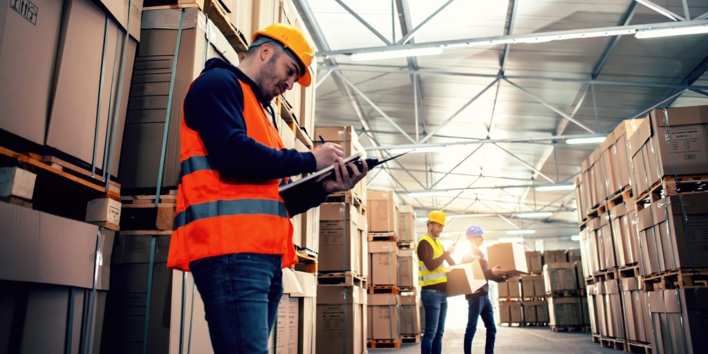 man looking at tablet on a working site