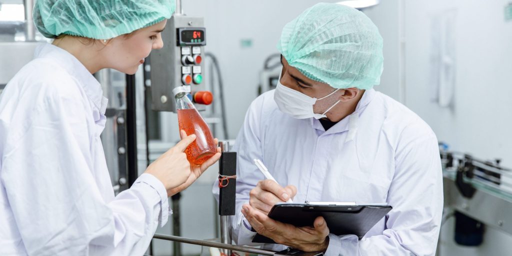 Man and woman inspecting a product