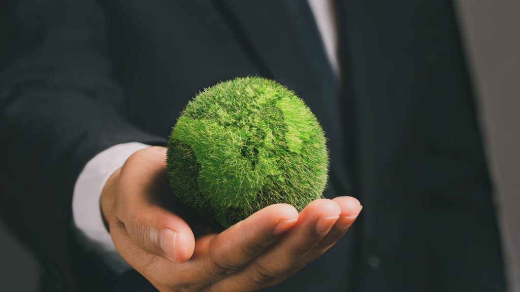ESG reporting - man holding a green globe